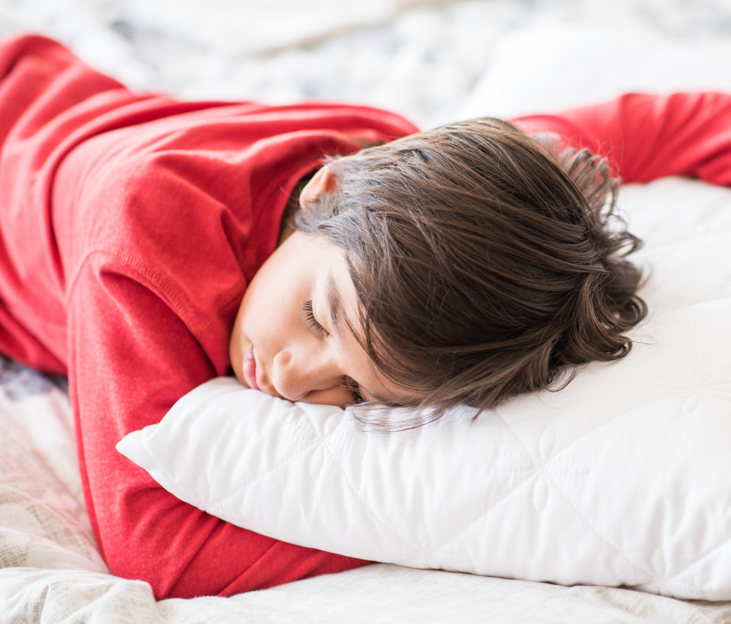 Child Sleeping on Bed 